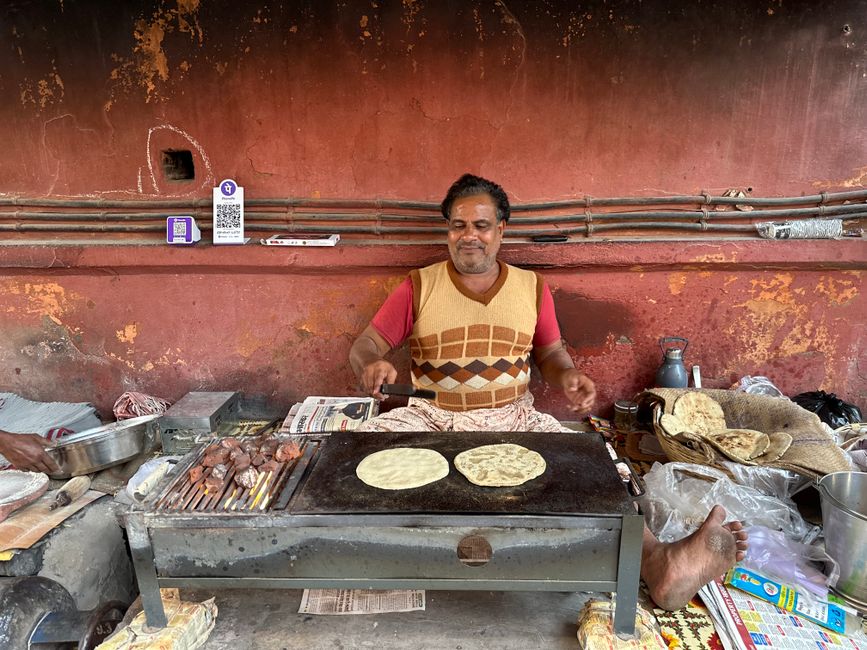 Cooking Indian flatbread over open flame
